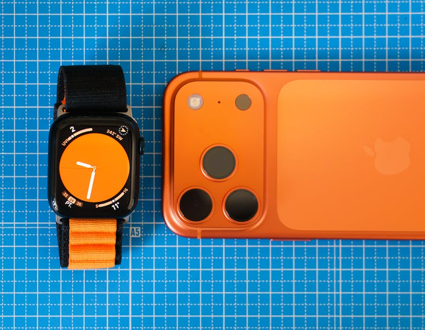 Minimalist setup featuring an orange-themed smartphone and smartwatch on a blue grid background.