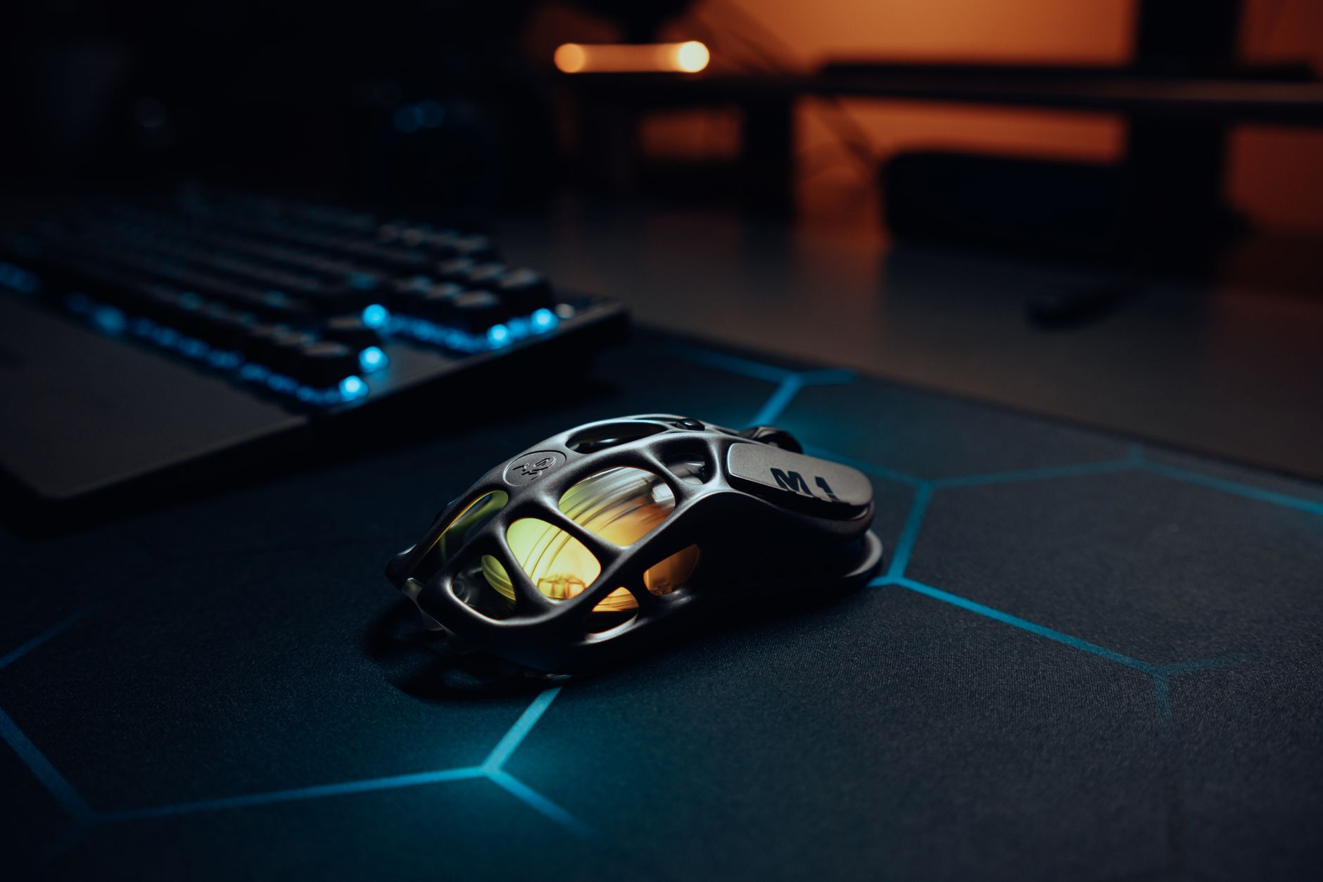 Product Spotlight image of Side or three-quarter view of the Cooler Master MM711 honeycomb shell mouse on a clean surface or gaming desk, highlighting its lightweight perforated design