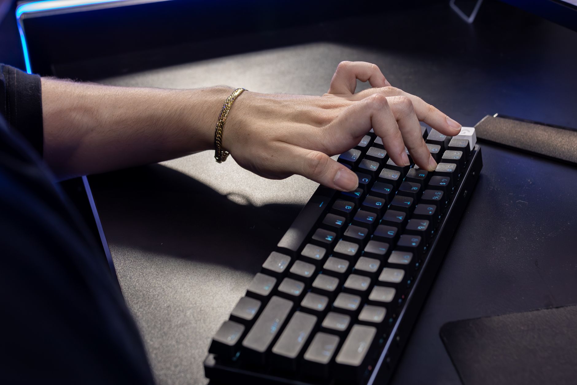 Best for Office Use image of Person typing on the Logitech MX Keys S at a work desk, showing the low-profile keys and backlit legends in a realistic office or home-office setting