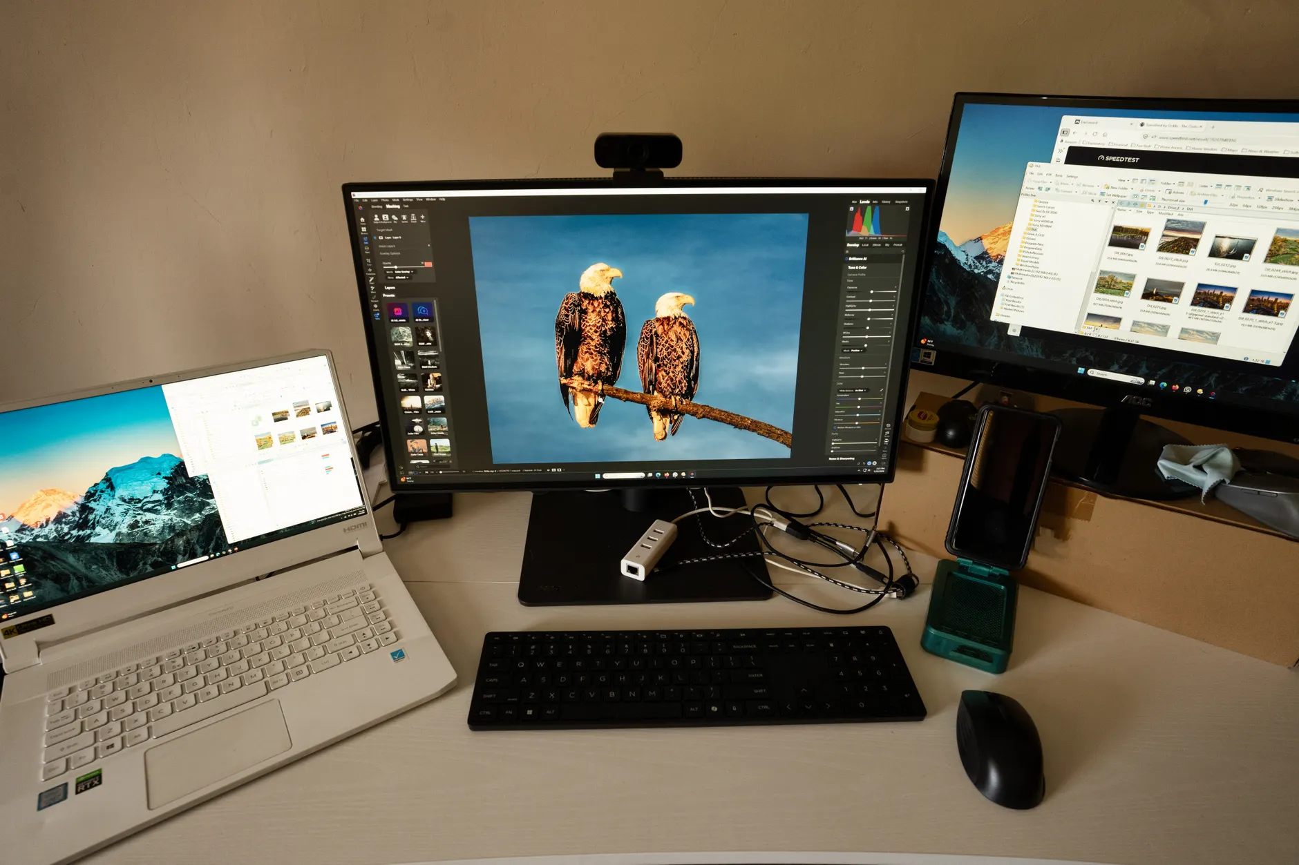 Best for Creatives image of Hands-on or unboxing photo of the BenQ PD2705UA monitor showing the display and rear USB-C hub ports, ideally on a desk with a connected MacBook or laptop