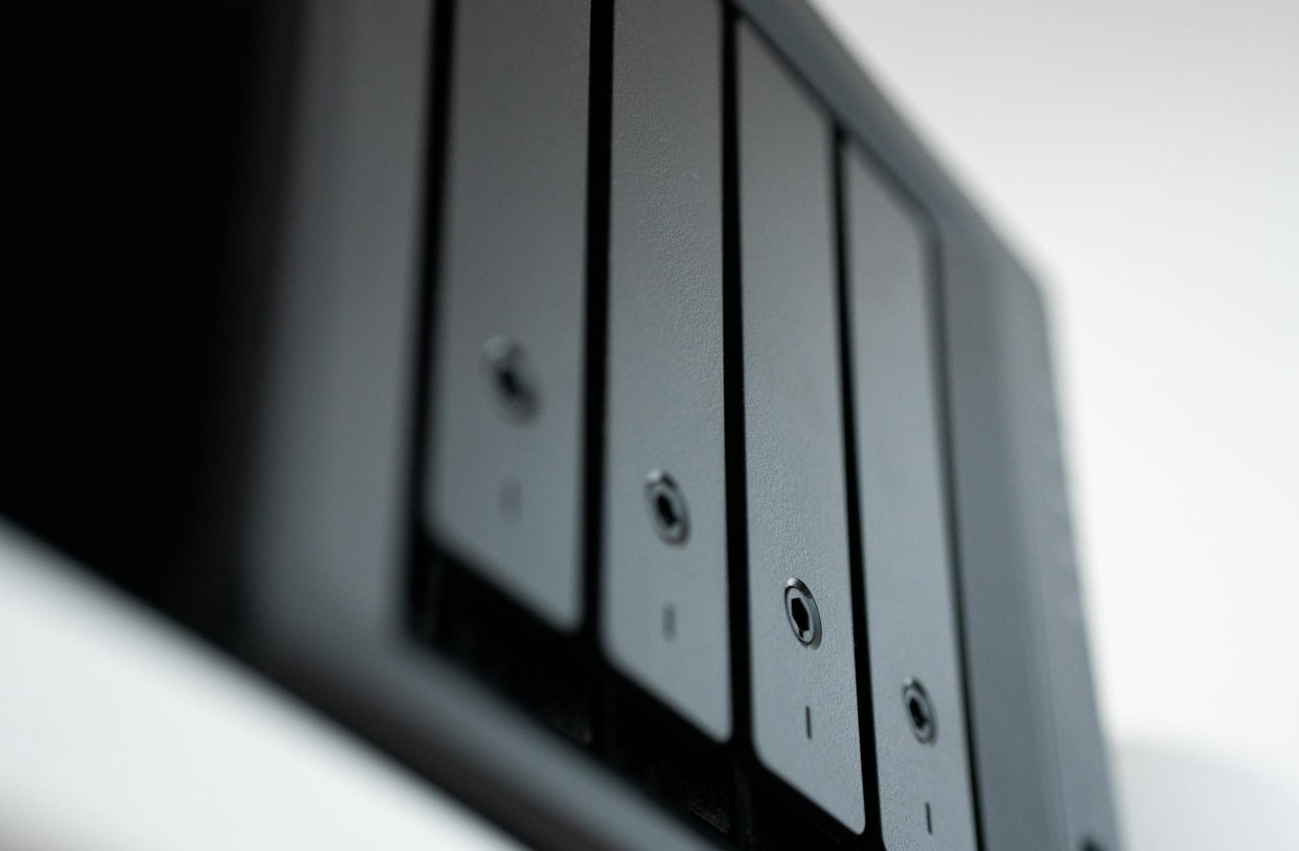 Budget Pick image of Real-world hands-on or unboxing photo of the QNAP TS-233 two-bay NAS showing the compact device being handled or set up on a desk