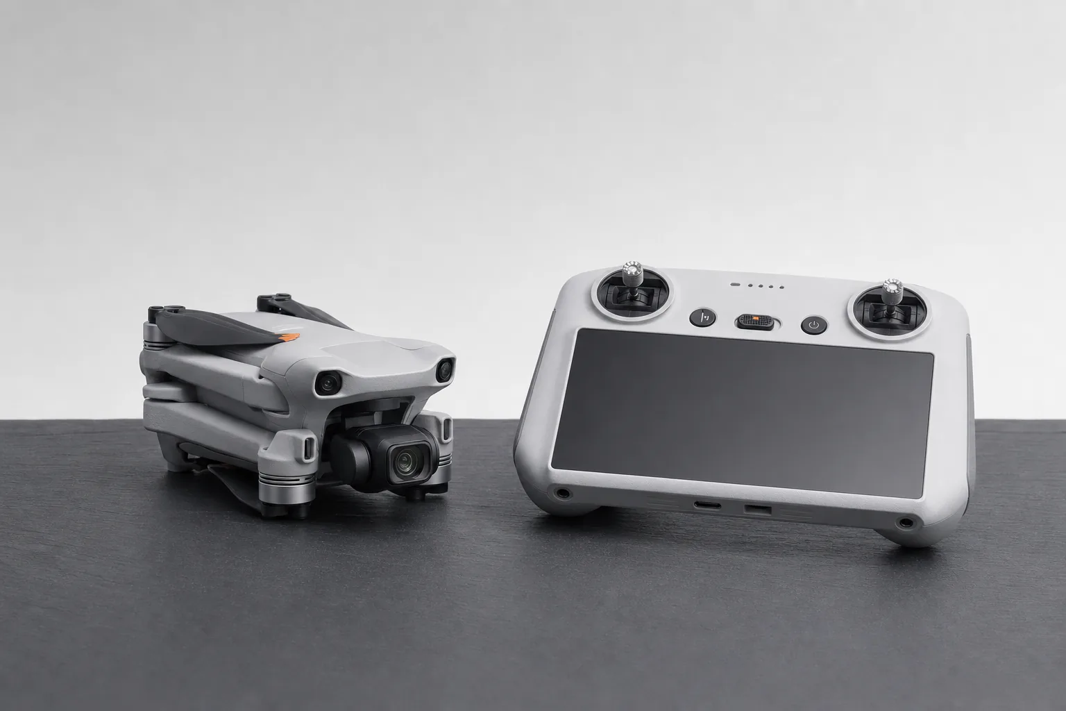 DJI Mini 5 Pro beside the DJI RC 2 controller with built-in screen