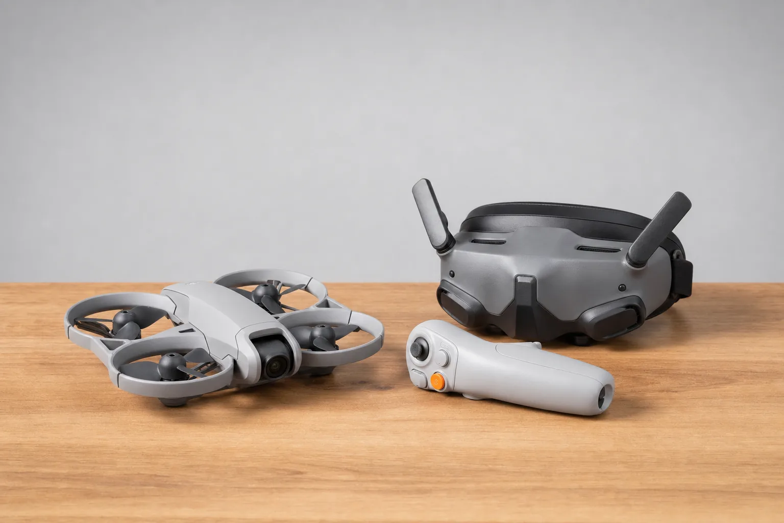 DJI Neo 2 with motion controller and goggles laid out on a wooden table