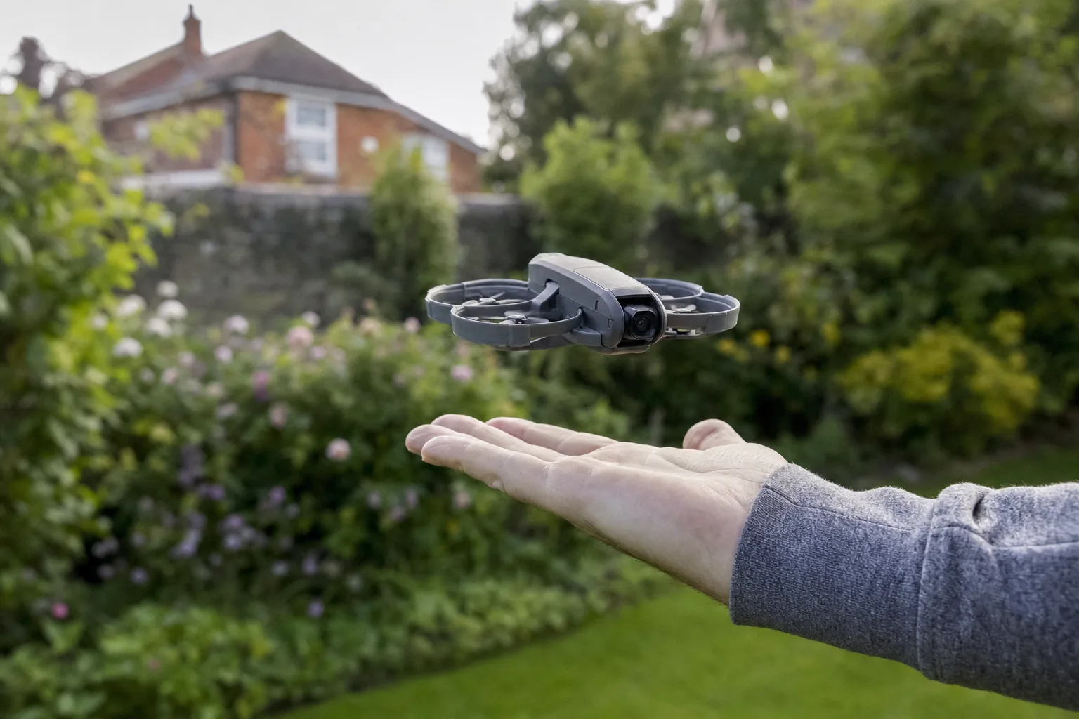 DJI Neo 2 taking off from an outstretched palm in a garden