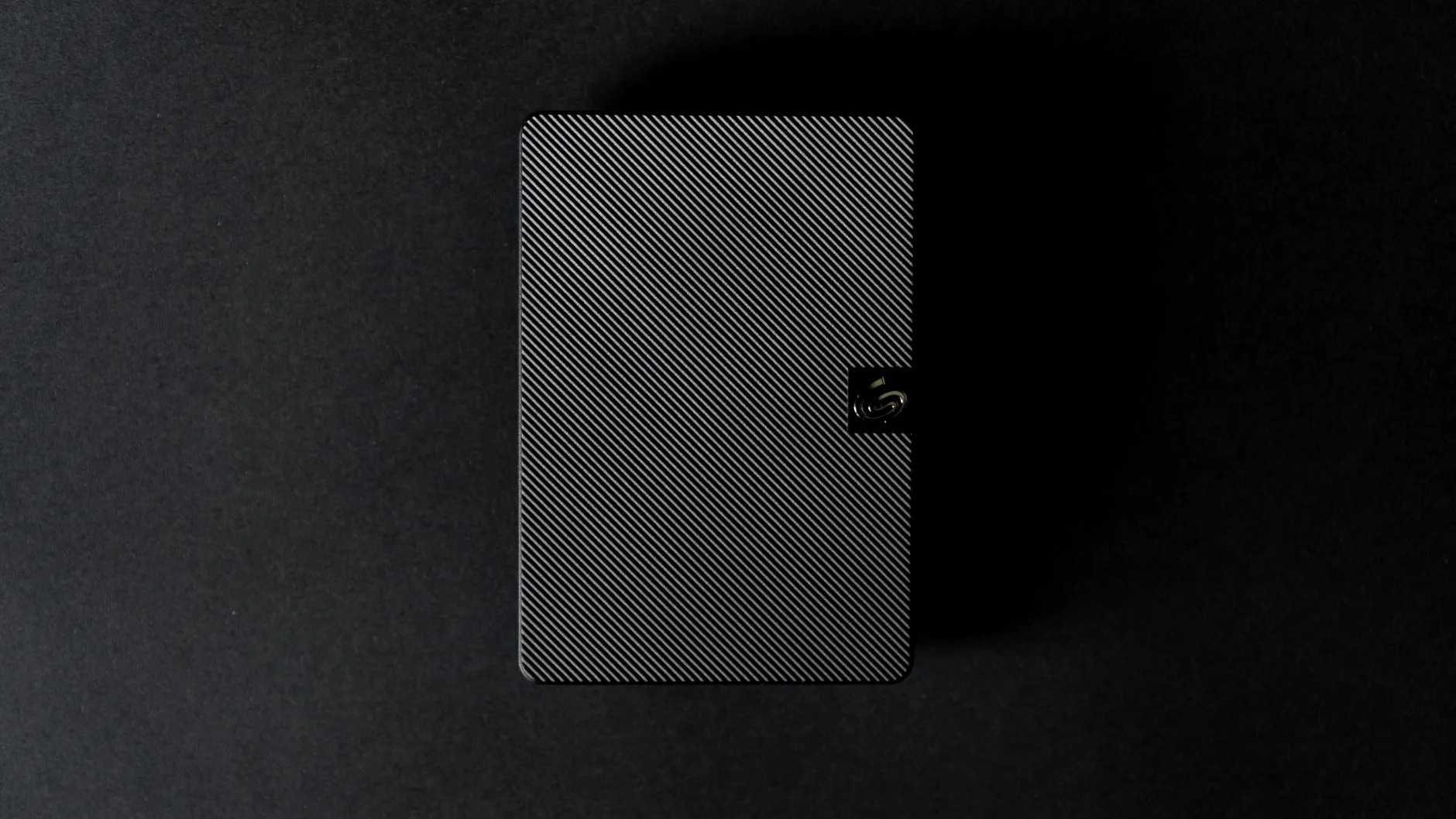 Hero image of Clean press or review photo of the Samsung T9 external SSD held in hand or on a clean surface, showing the physical product clearly