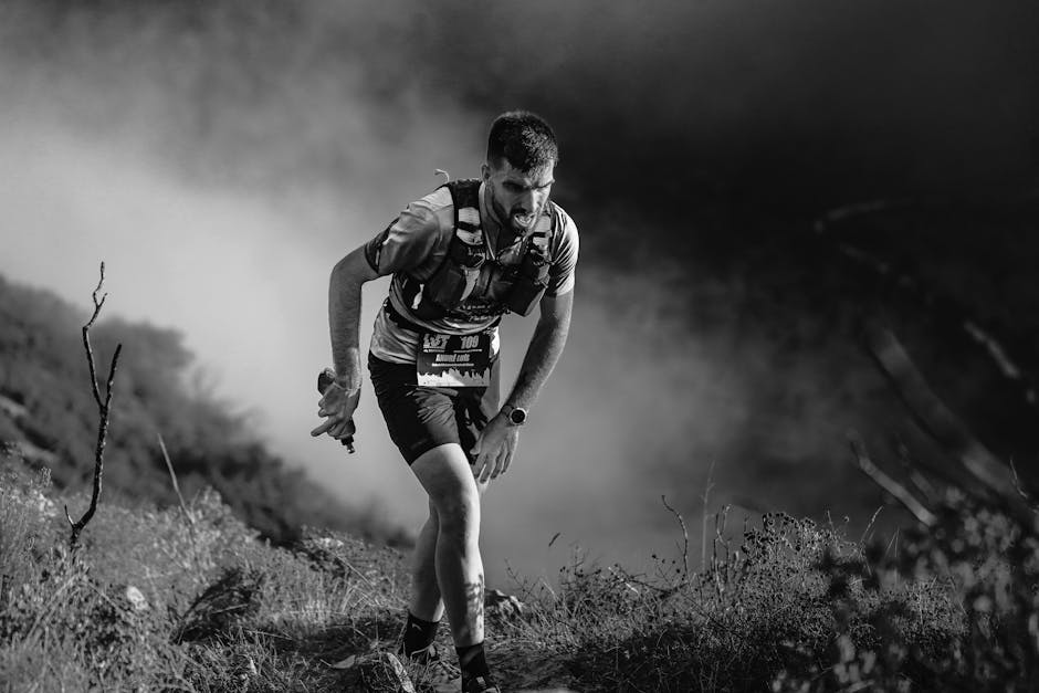 Focused athlete navigating rugged terrain during a competitive trail run.