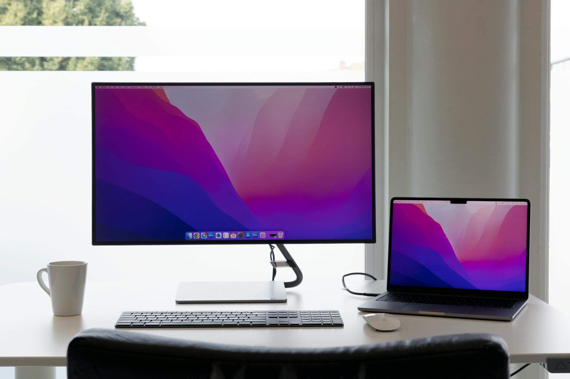 Product Comparison image of Hands-on or unboxing photo of two LG 27UK850 monitors arranged in a dual setup, showing bezels and stand clearly