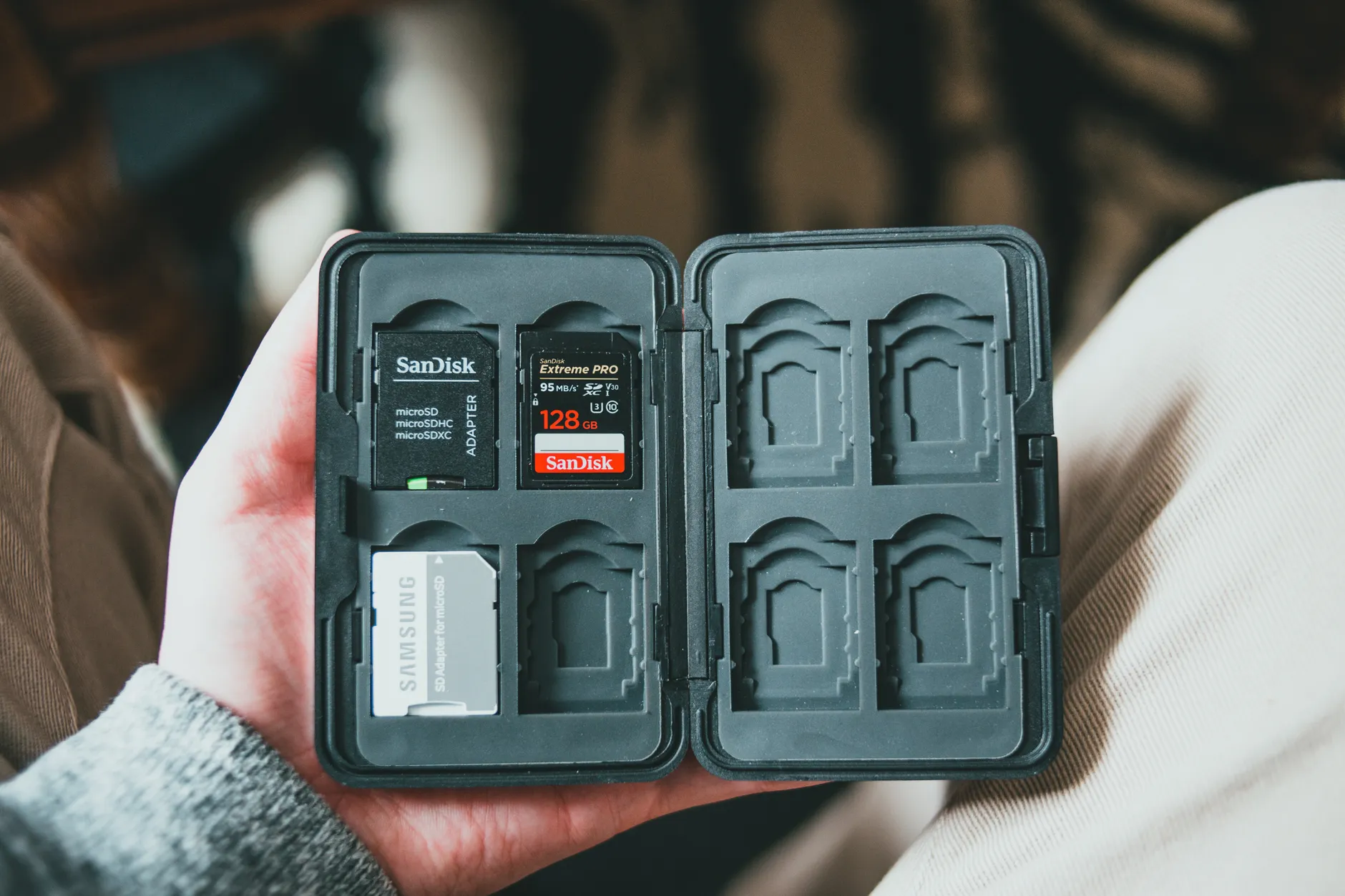 Camera Compatibility image of Hands-on photo of a SanDisk Extreme microSD card being inserted into a DSLR or mirrorless camera card slot