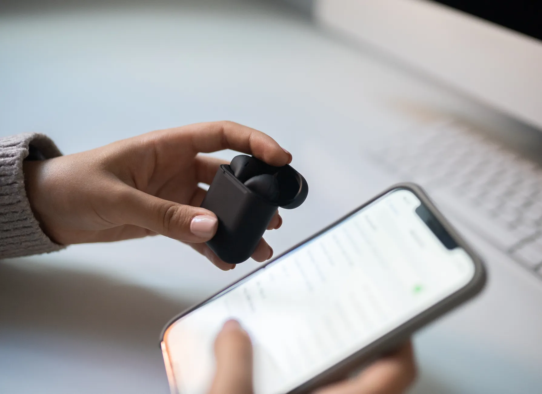 Hero image of Clean, well-lit photo of a person pairing a Bluetooth device to a Windows laptop or smartphone, showing the Bluetooth settings screen clearly visible