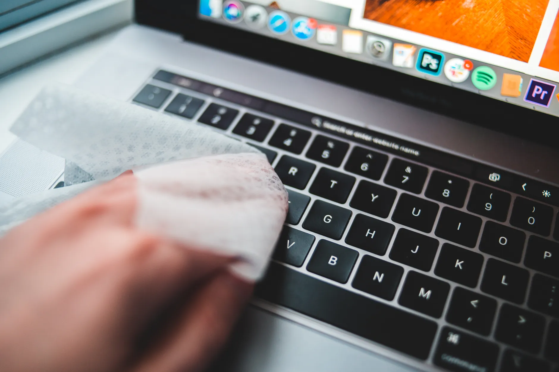 Hero image of Clean, well-lit photo of a person performing a factory reset or data wipe on a laptop, screen clearly visible showing settings or reset screen, professional real-world use
