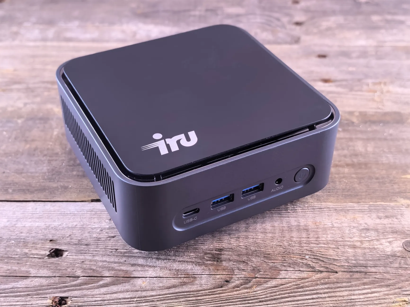 Mini PC Comparison image of Real-world photo of the Beelink SER5 Max mini PC in a home office or desk setup, showing ports and compact size in context