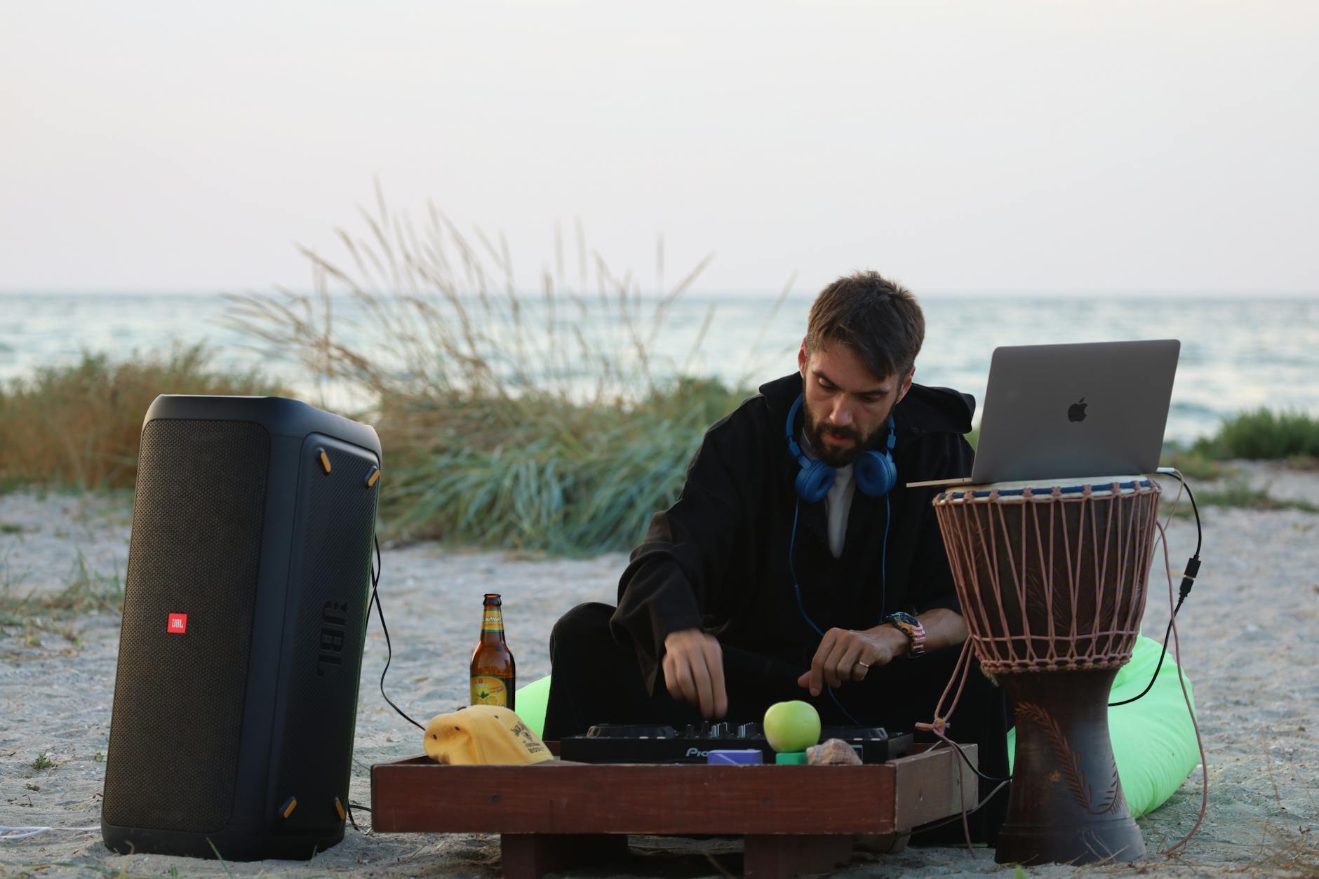 Real World Use image of Real-world photo of a JBL PartyBox 2026 speaker in use at a party or gathering with lighting effects active and people around it
