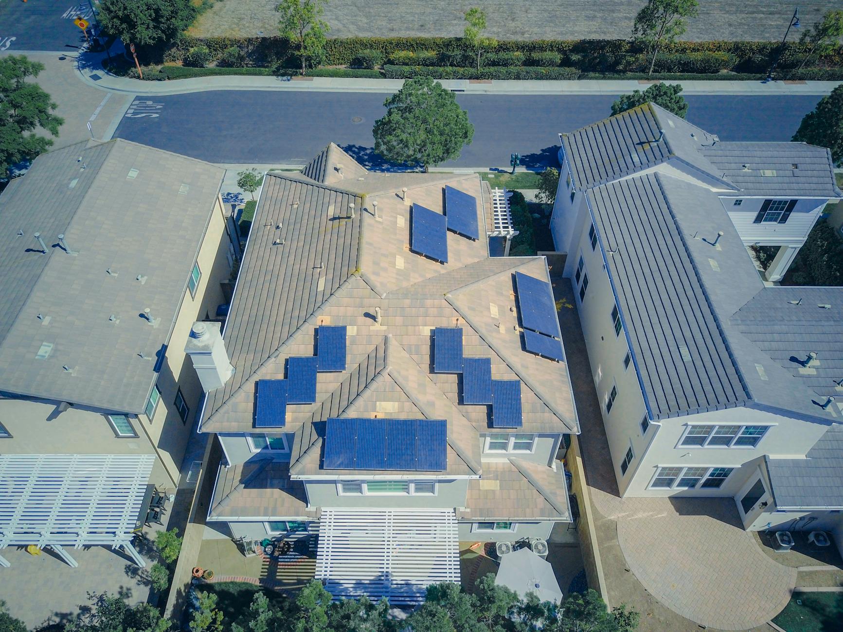 Hero image of Clean front view of solar panels installed on a residential rooftop by a professional solar company, bright daylight, showing full array