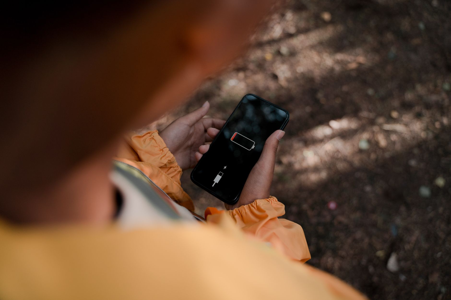 Hero image of Clean close-up of a smartphone screen displaying a low battery percentage warning, clearly visible on a real device held in hand