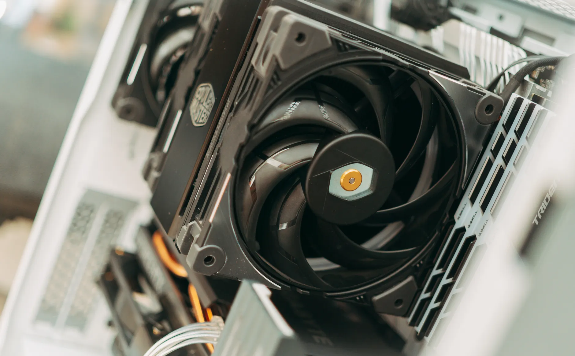 Hero image of Clean close-up photo of a spinning PC case fan inside a desktop tower, showing dust buildup or fan blades clearly, real hardware photography
