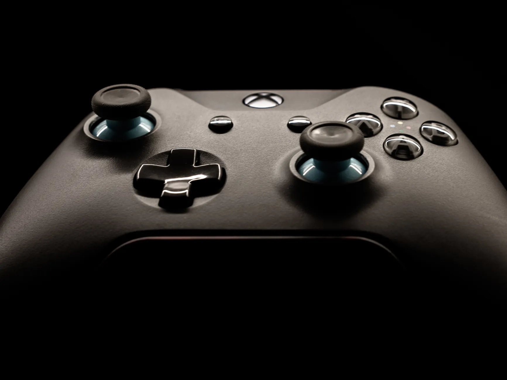 PC-Console Hybrid Software image of Close-up of a Windows-based handheld gaming PC screen showing the Xbox Game Pass or Windows gaming interface, with physical controls visible